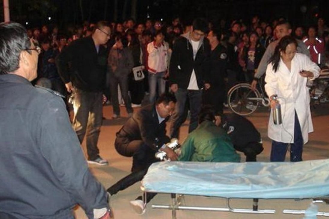 People rescue a victim after the deadly hit-and-run involving Li Qiming, son of senior police official Li Gang in Hebei. Photo: SCMP