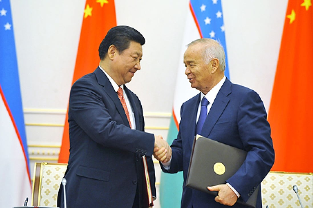 President Xi Jinping and Uzbekistan's President Islam Karimov shake hands as they exchange signed documents in Tashkent, Uzbekistan on Monday. Photo: AP