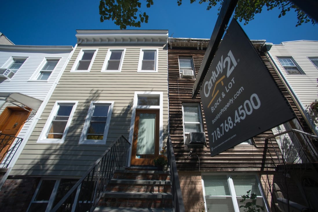 A "For Sale" sign outside a home in Brooklyn, New York, where buying is still more than 20 per cent cheaper than renting. Photo: Bloomberg