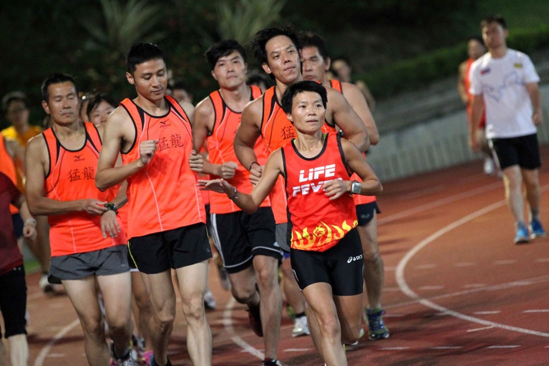 Kate Cheung helps guide blind and deaf runners at Hammer Hill Sports Ground, Choi Hung. Photo: SCMP Pictures