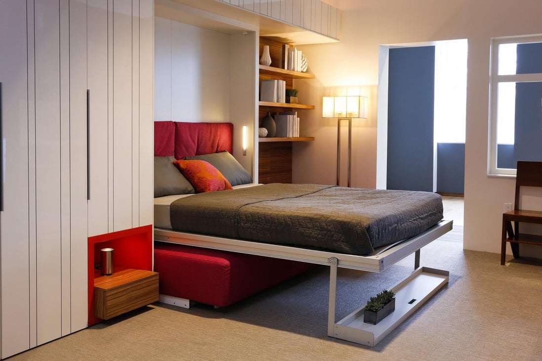 A bed concealed in a wall behind a sofa helps to maximise space. Photo: Resource Furniture and Clei
