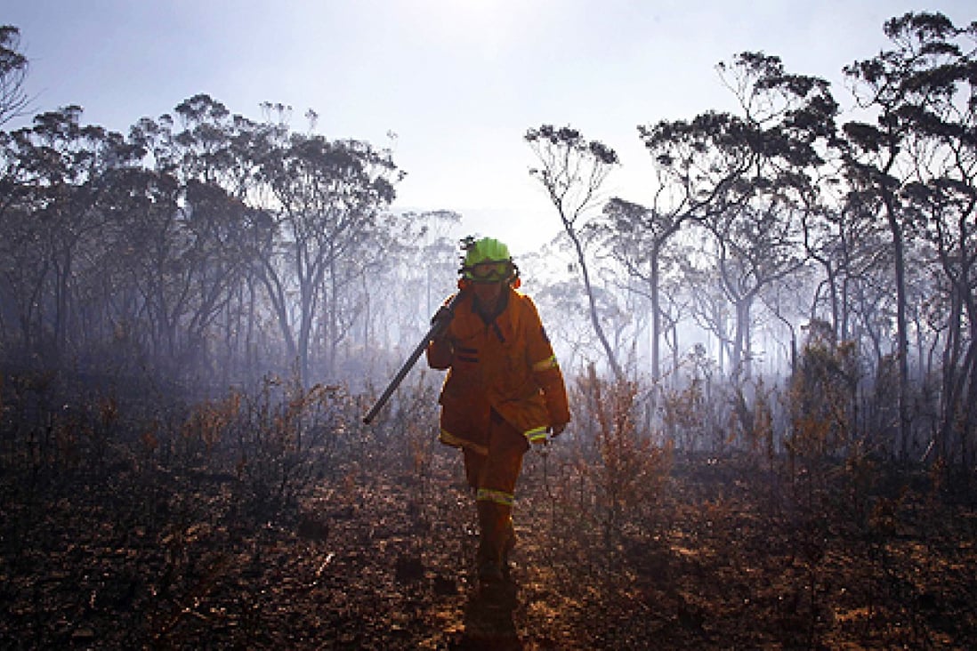A female Rural Fire Service firefighter near the Blue Mountains, west of Sydney on Wednesday. Photo: Reuters