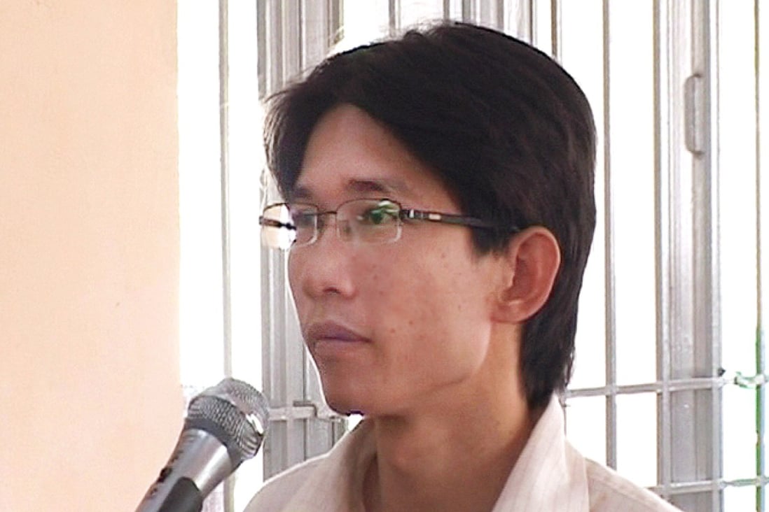 Activist Dinh Nhat Uy stands trial at a local People's Court in the southern city of Long An on Tuesday. Photo: AFP