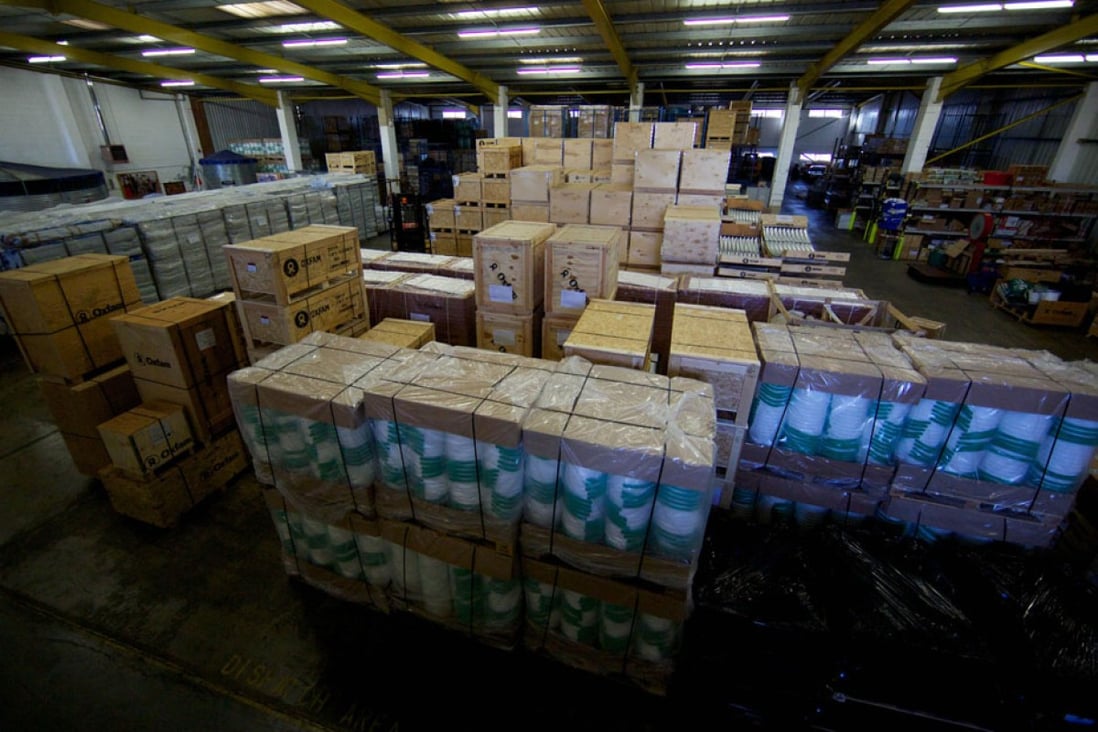 Aid packages as part of efforts to assist victims of Typhoon Haiyan are ready to be shipped in an Oxfam UK warehouse. Beijing's initial US$200,000 donation to the Philippines has drawn criticism. Photo: AFP