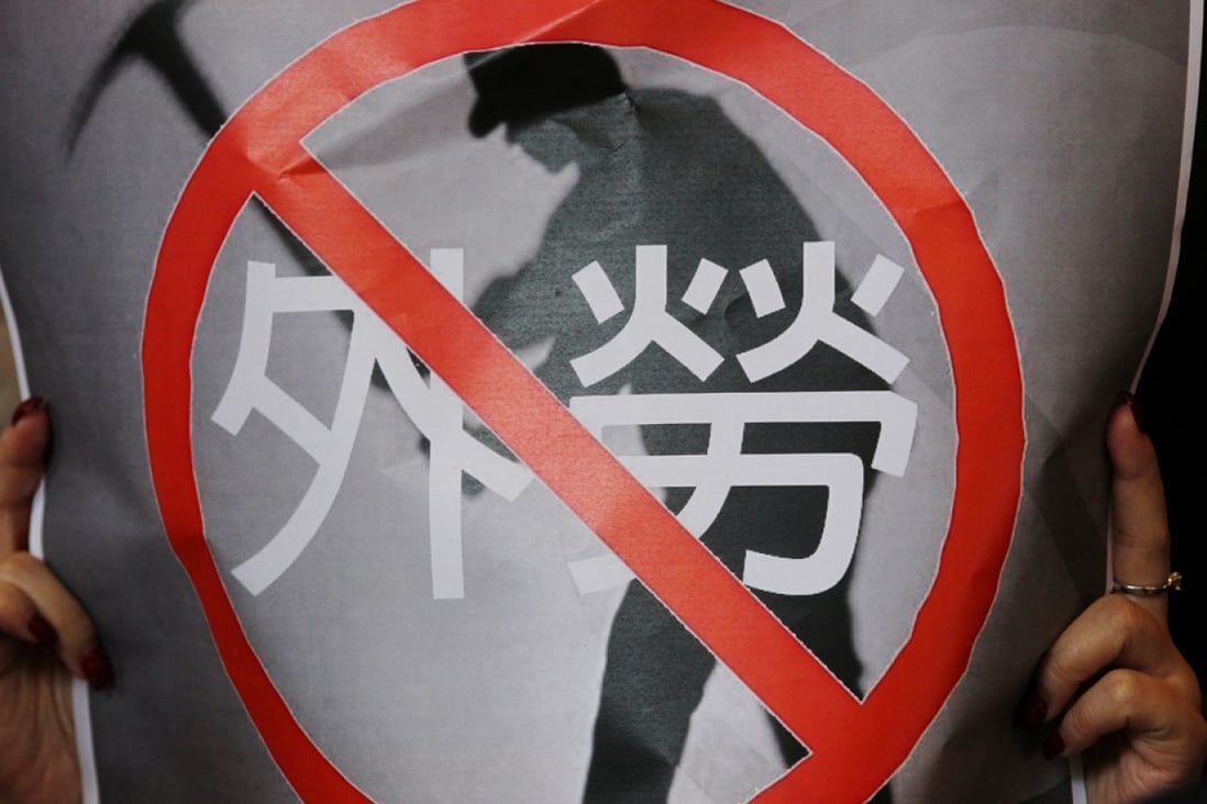 A protester's poster says no to foreign labour. Photo: K. Y. Cheng
