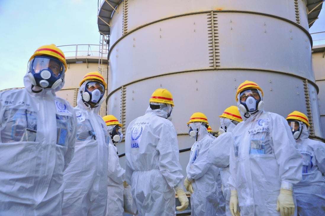 International Atomic Energy Agency experts check out water storage tanks at Tepco's Fukushima Daiichi nuclear power station. Photo: Reuters