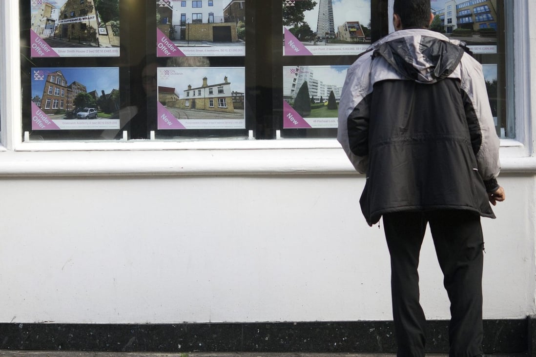 A potential London buyer looks at homes for sale. Photo: Bloomberg