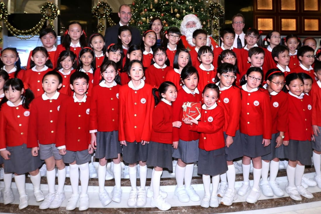 Children from the Singapore International School perform Christmas carols at the Kowloon Shangri-La Christmas tree lighting ceremony on Wednesday.  Photo: K. Y. Cheng