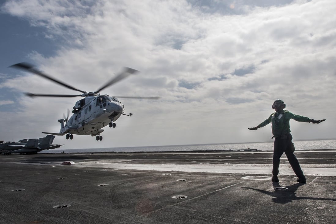 A helicopter of the Japan Maritime Self-Defence Force lifts off. Photo: Reuters