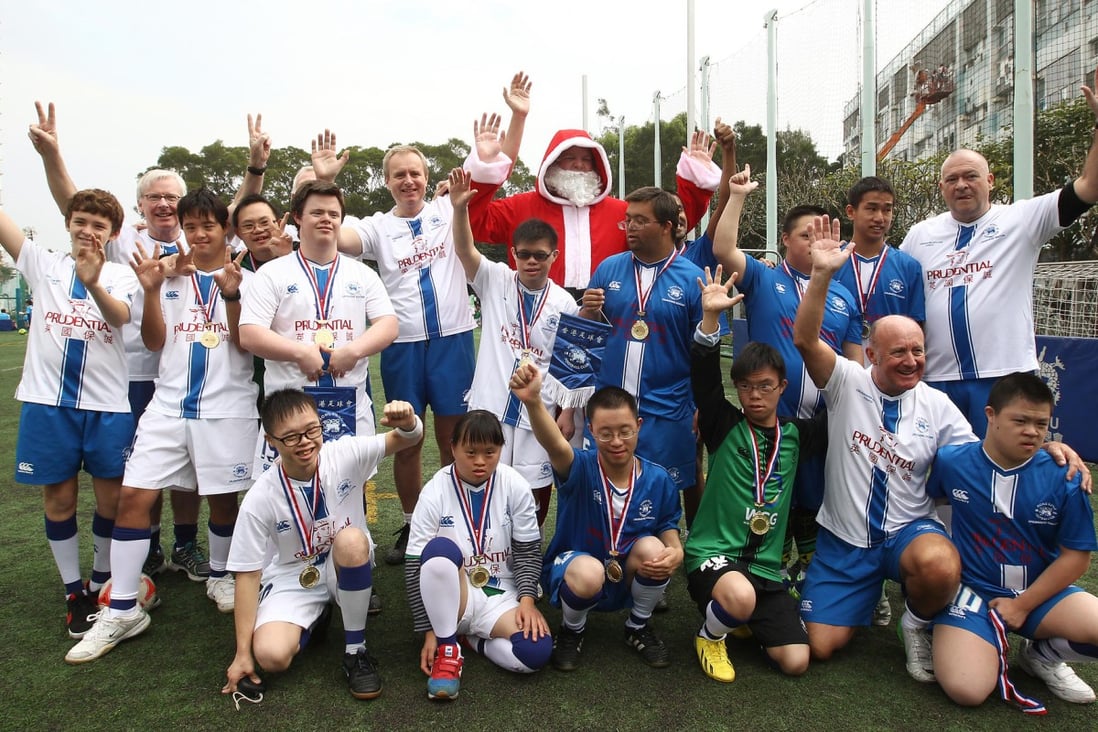 Players and coaches of the Hong Kong Football Club Crusaders at the tournament with their number one fan. Photo: Jonathan Wong