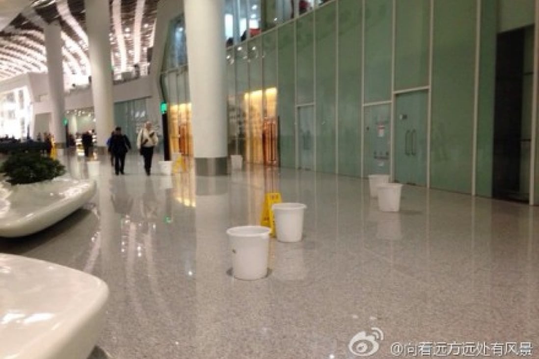 Screengrab from Weibo showing janitors putting buckets on the floor to collect leaking water in the terminal building