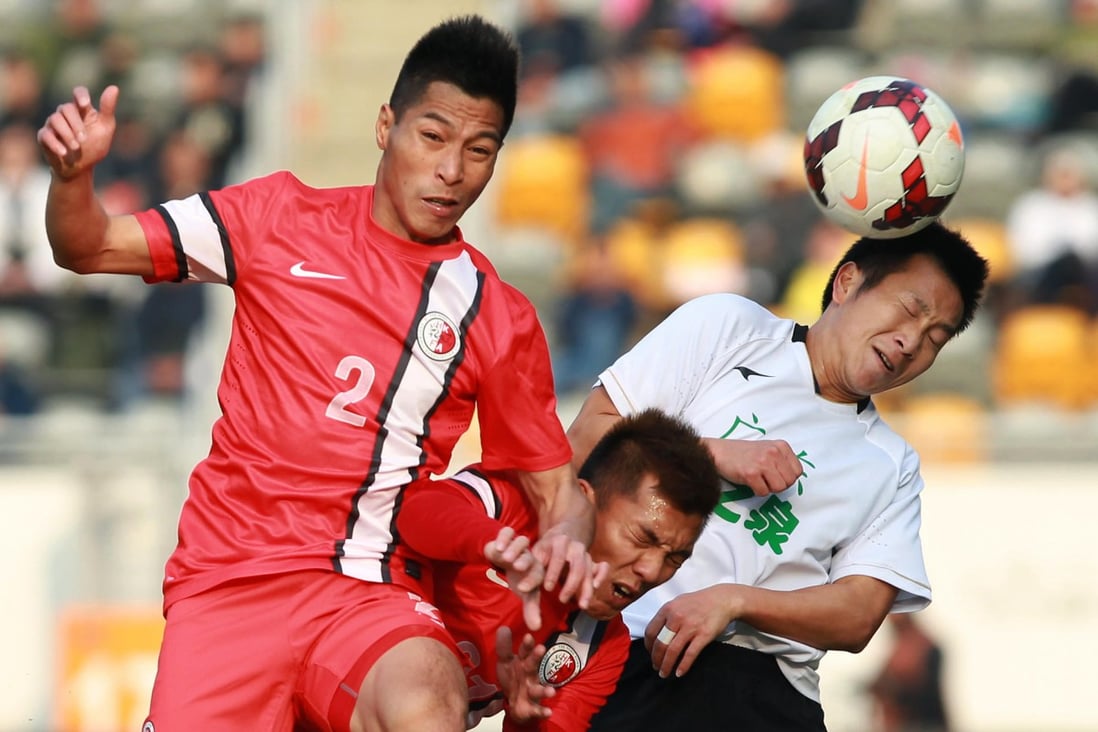 Hong Kong's Lee Chi-ho and Kwok Kin-pong battle Guangdong's Lu Lin during the first leg of the Interport Cup. Photo: Dickson Lee