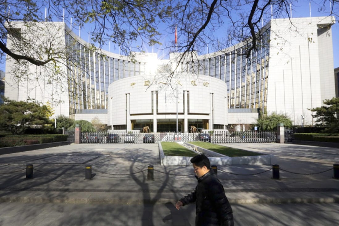 A man walks past the headquarters of the PBOC in Beijing. Photo: 