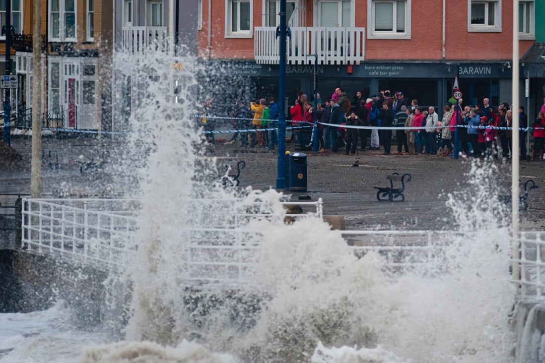 The promenade wall in Aberystwyth, West Wales takes a battering from waves driven by storm-force winds as gales and heavy rain continue to lash most parts of the country, particularly along the coastline, causing flooding in inland areas. Photo: EPA
