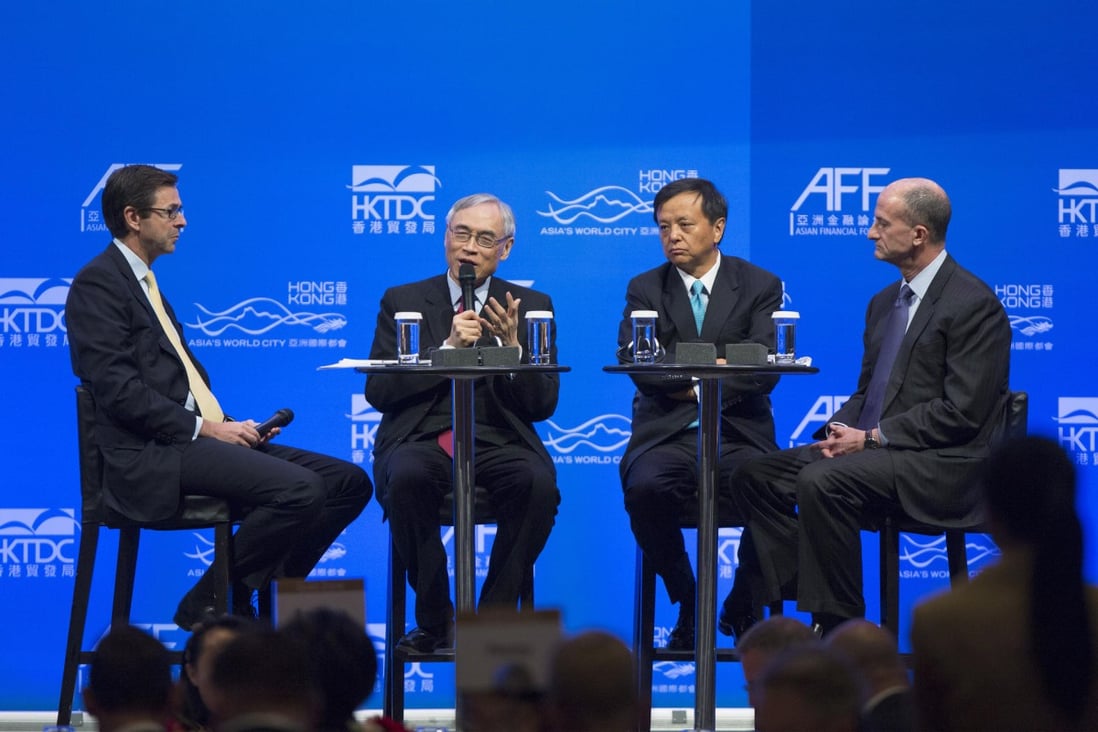 CIC International chairman Lawrence Lau (second left) speaking at the forum with (left) Mark McCombe, Asia-Pacific chairman of BlackRock, (second right) Charles Li, chief executive of HKEx, and (right) General Electric vice-chairman John Rice at the forum. Photo: Bloomberg