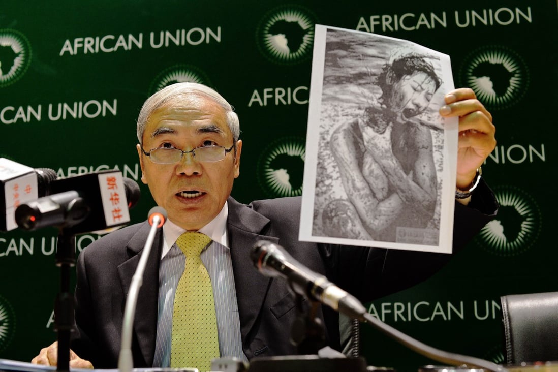 Xie Xiaoyan holds a photo of an alleged Japanese war crime at a press conference  in Addis Ababa on Wednesday. Photo: AFP