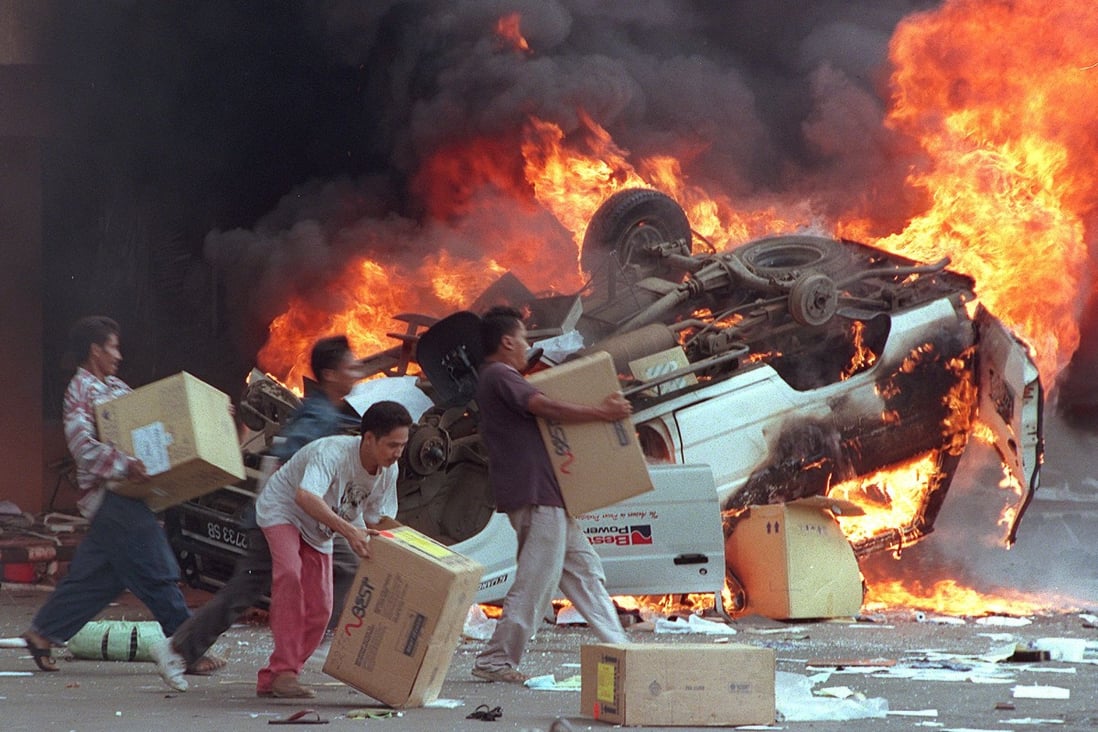 This 1998 photo shows angry Indonesian mobs burning cars and Chinese shops as they plundered shops in Jakarta. Photo: AFP