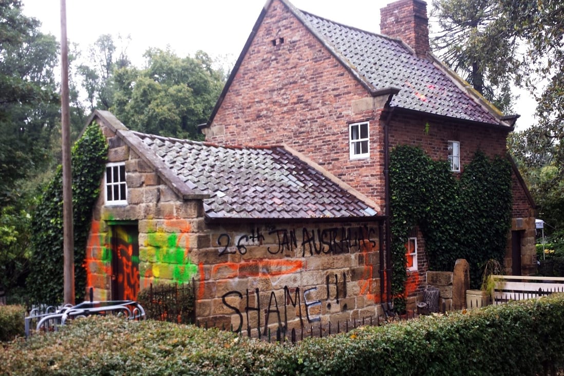Graffiti sprayed on the exterior of Captain Cook Cottage in Melbourne. Photo: EPA