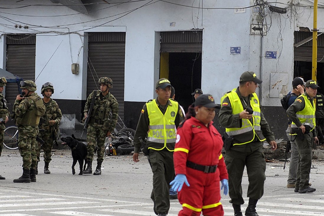 Colombian security forces inspect the site of a car bomb explosion in the Valle del Cauca region on January 16. Photo: AFP
