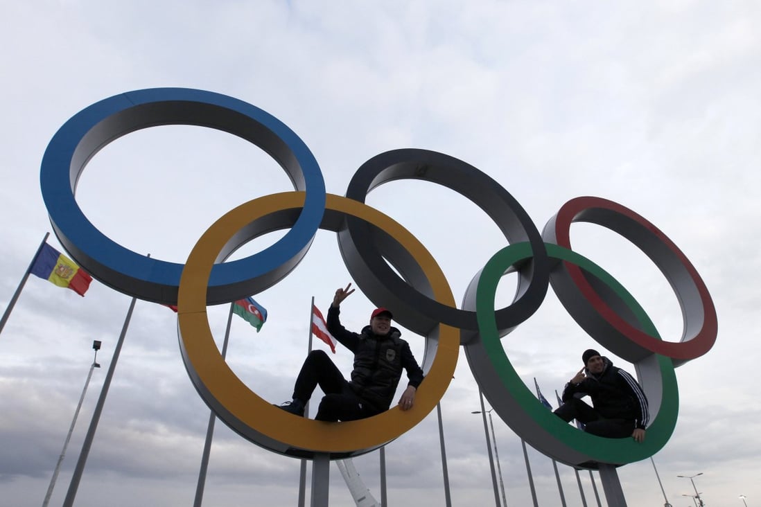 Two men sit inside a set of Olympic rings on display at the Olympic Park as preparations continue for the Sochi 2014 Winter Olympics Photo: REUTERS