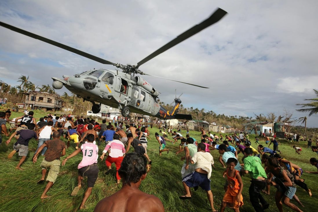 Filipinos rush to get relief goods from a US Navy helicopter in November in the town of Salcedo on Samar Island. It was one of the areas that were devastated by Typhoon Haiyan. Photo: EPA