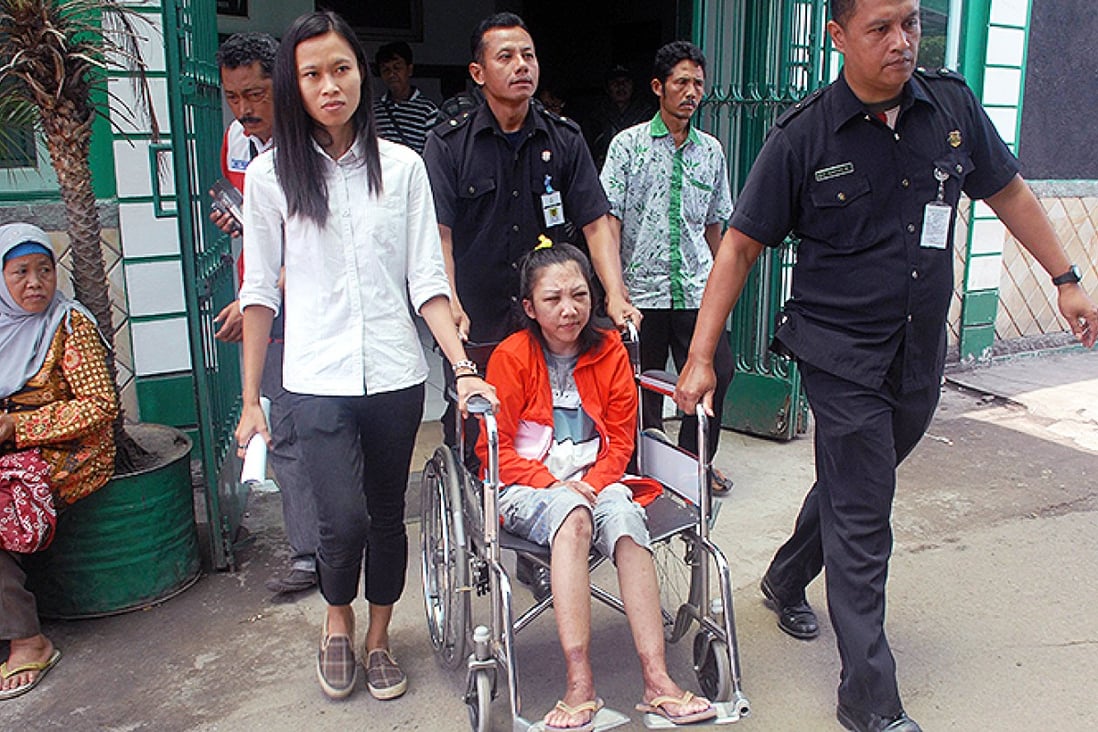 Indonesian maid Erwiana Sulistyaningsih, 23, is wheeled out of hospital before heading to her family home. Photo: AFP