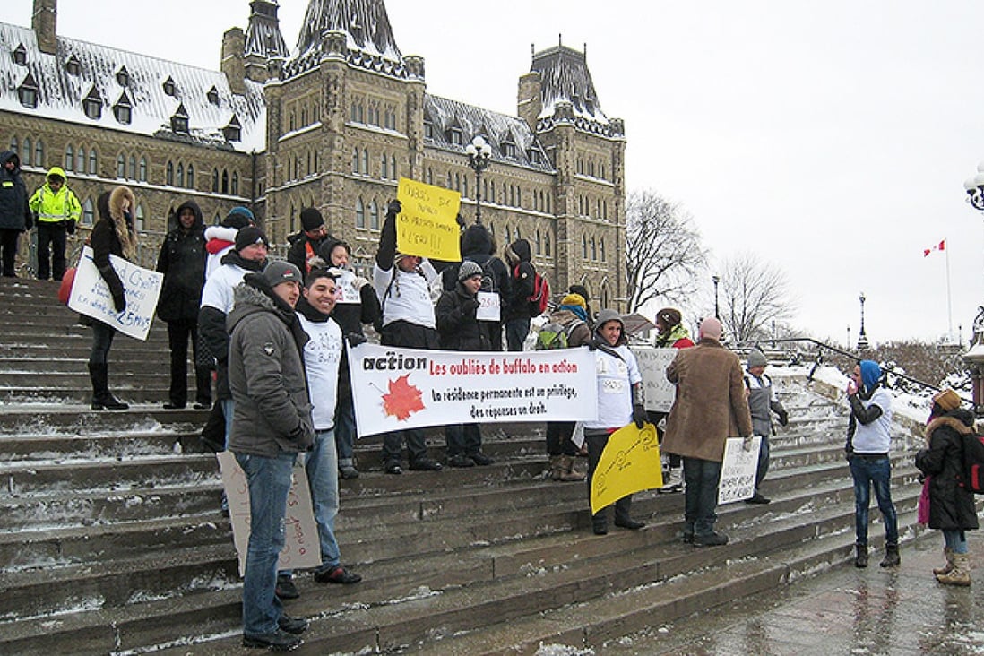 Protesters gather in front of the Canadian parliament in Ottawa as thousands of immigrants pressed Canada's government to fast-track their permanent residency applications. Photo: AFP