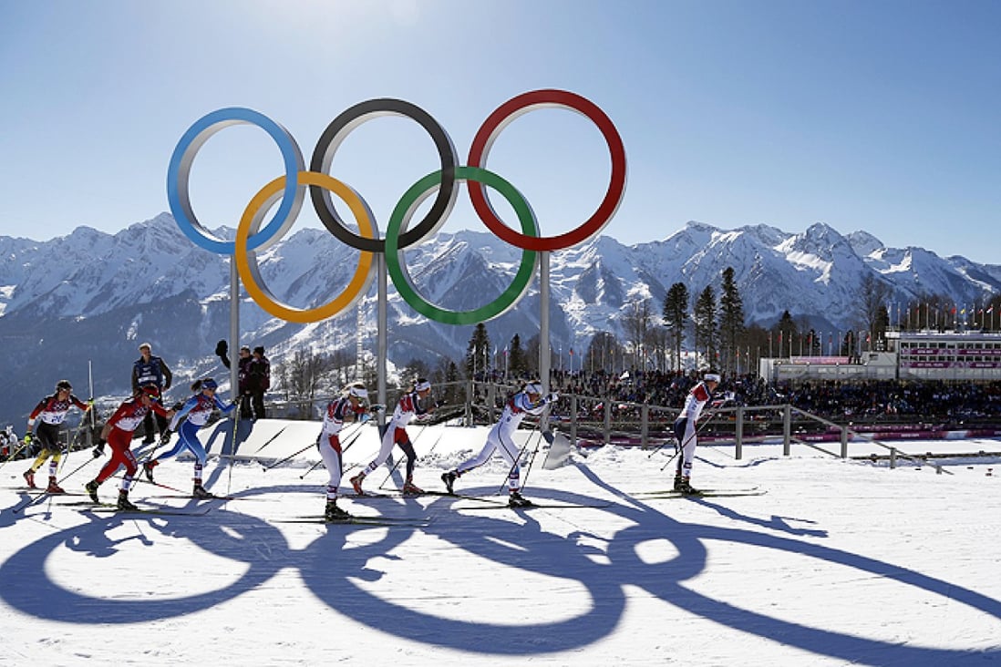 Norway's Marit Bjoergen leads as she skis past the Olympic rings on her way to winning the women's cross-country 15km skiathlon. Photo: AP