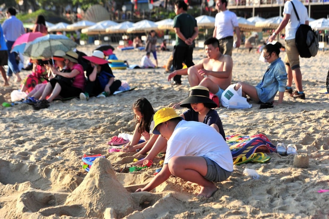 Tourists on a beach in Sanya. Hainan authorities have announced a crackdown on nude sunbathers. Photo: Xinhua