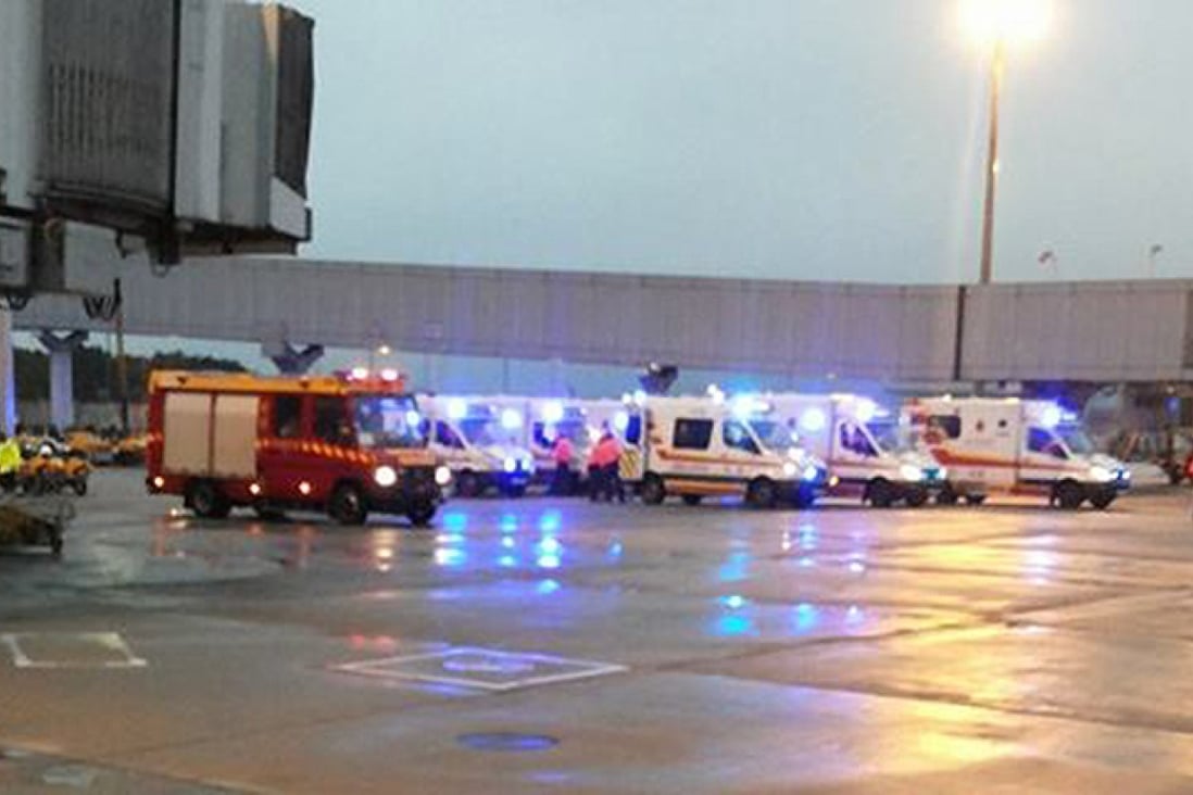 Ambulances wait for the arrival of the turbulence-hit Cathay flight at Chep Lap Kok airport. Photo: SCMP Pictures