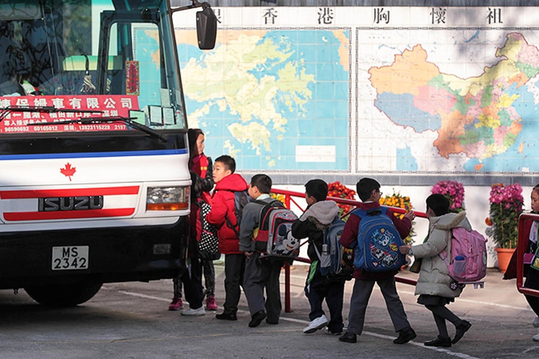 Fung Kai No1 Primary School students in Sheung Shui board their bus in front of maps of Hong Kong and the mainland. Photo: Thomas Yau