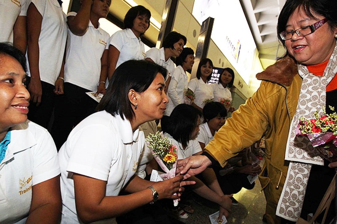 The first group of Myanmese domestic workers is welcomed by recruitment agents at the Chek Lap Kok upon arrival in Hong Kong.  Photo: Nora Tam