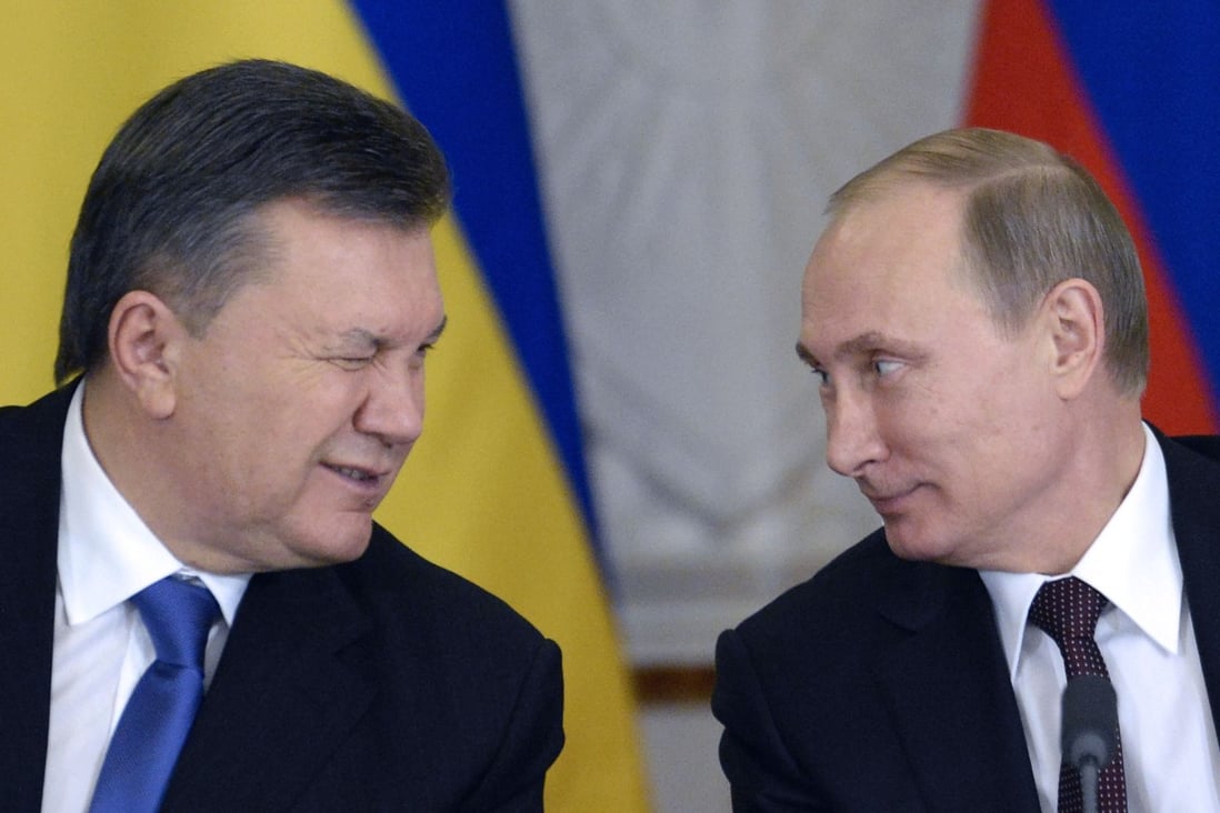 Ukraine's deposed president Viktor Yanukovych (left, winking at Russia's president Vladimir Putin) often bragged about corruption, says Georgia’s former president Mikhail Saakashvili. Photo: AFP