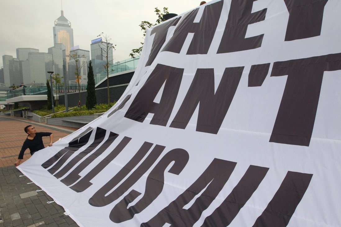 An HKJA banner is unfurled at Tamar. Photo: Felix Wong