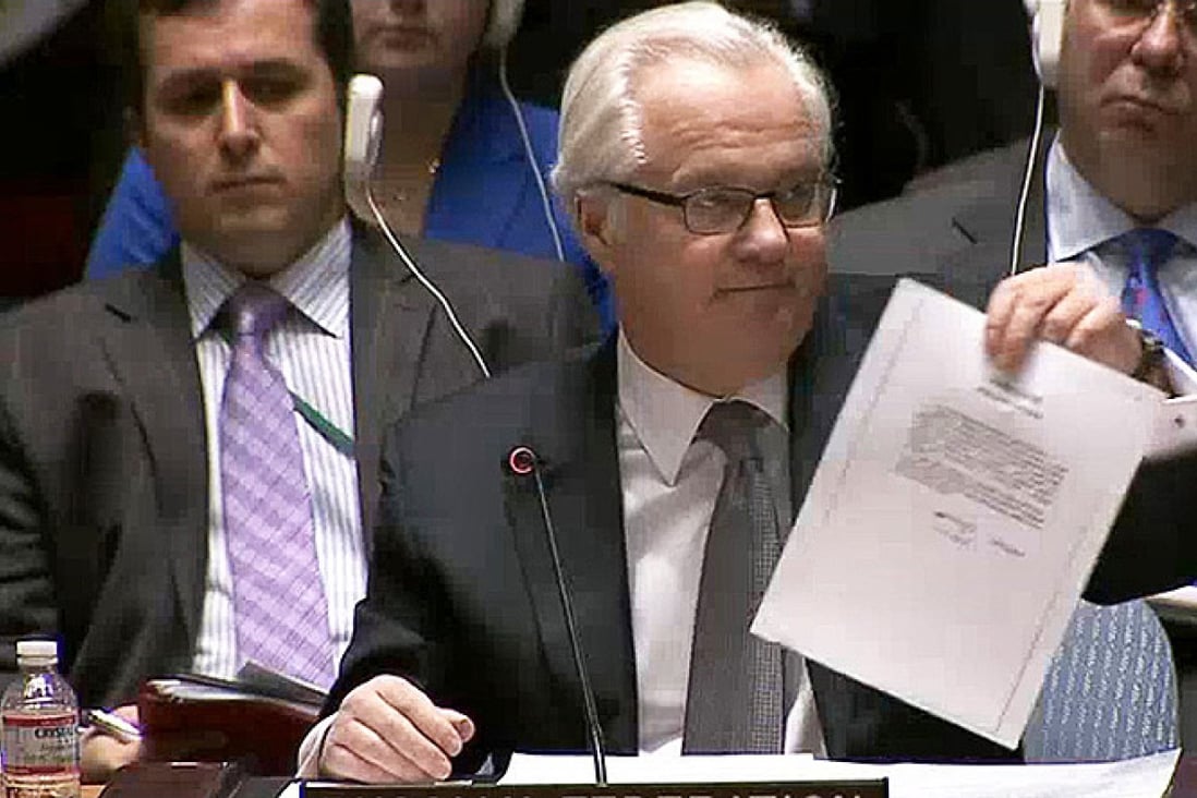 Vitaly Churkin, Russia's ambassador to the UN, shows a letter to purportedly from ousted Ukrainian leader Viktor Yanukovich to Vladimir Putin asking the Russian leader for military intervention in Ukraine. Photo: Reuters