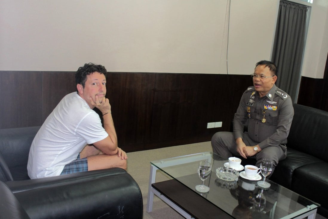 Italian tourist Luigi Maraldi speaks to a police officer in Phuket yesterday. Photo: Chutima Sidasathian