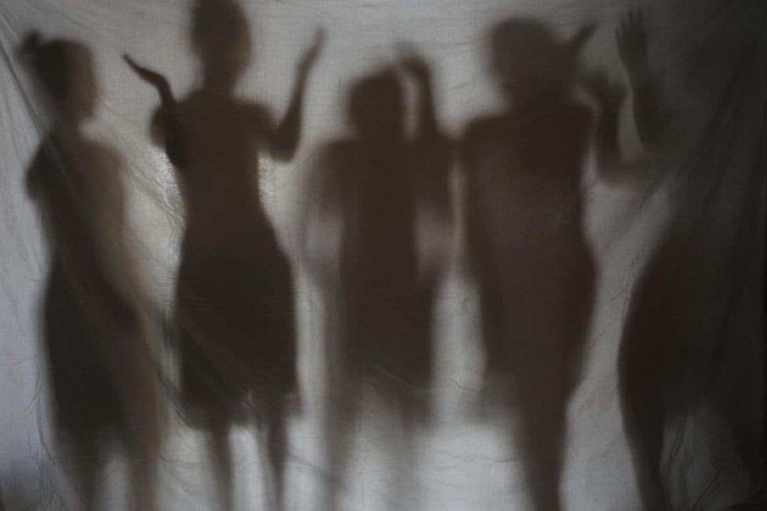 Young girls rescued by police from a cybersex den are seen in silhouette in Olongapo City in the northern Philippines in 2010. Photo: AFP