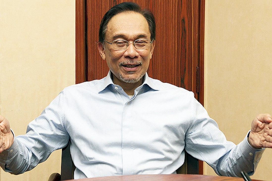 Malaysian opposition leader Anwar Ibrahim answers questions about the plane's disappearance in Kuala Lumpur. Photo: SCMP Pictures