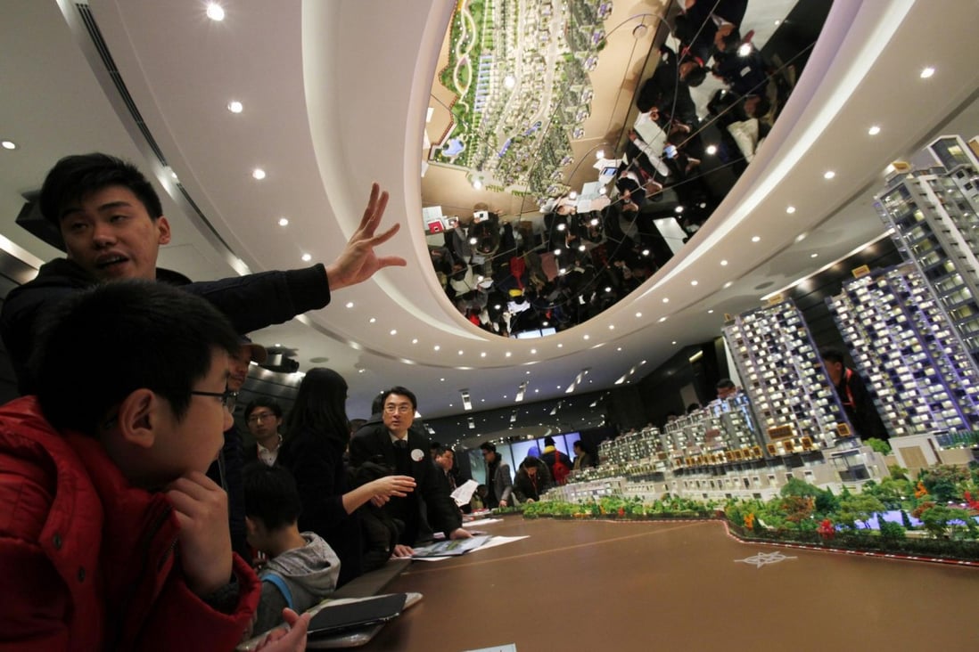 An agent speaks to potential buyers at a Sun Hung Kai Properties event. Developers are feeling the strain of labour costs. Photo: Reuters