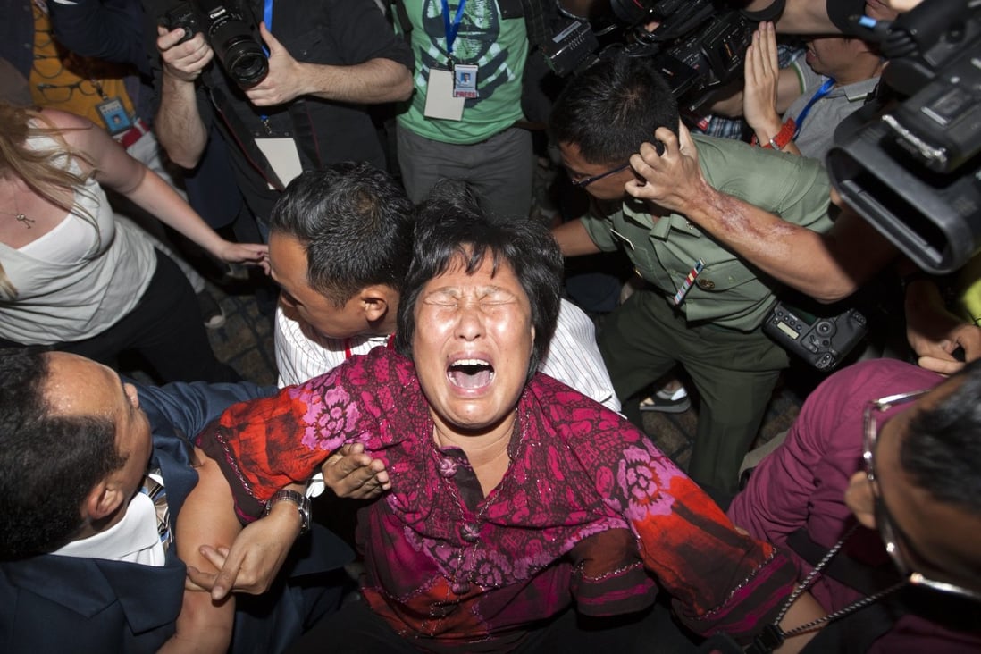 A family member of missing relative from China breaks down as she speaks to the media at Kuala Lumpur International Airport on Saturday. Photo: EPA