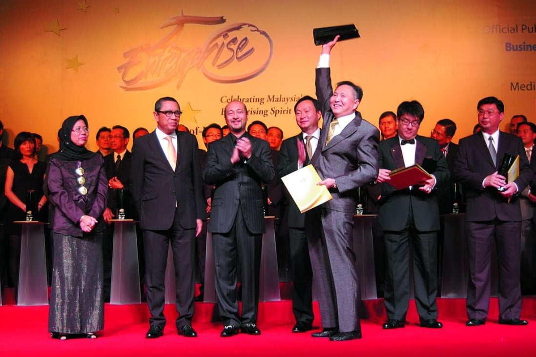 Multi-B managing director Chong Hong Wah holding the Enterprise 50 champion's trophy