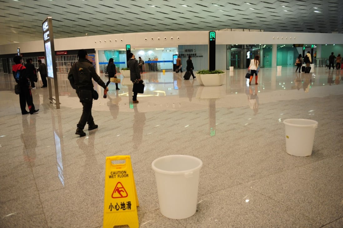 Visitors discover water leakage at the new airport terminal in Shenzhen last December, less than a month after it opened to public. Photo: CNS  