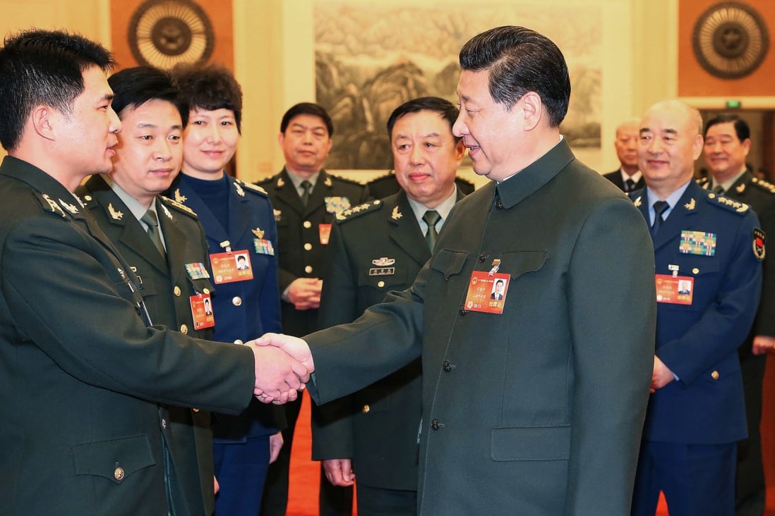 Chinese President Xi Jinping talks with a deputy to the 12th National People's Congress (NPC) from the People's Liberation Army (PLA) in Beijing on March 11. Photo: Xinhua