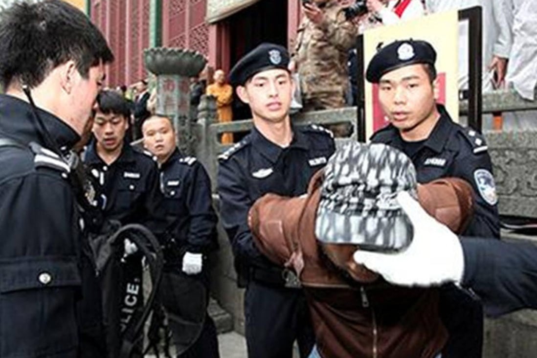 Members of the squad demonstrate how they would restrain a suspect. Photo: SCMP