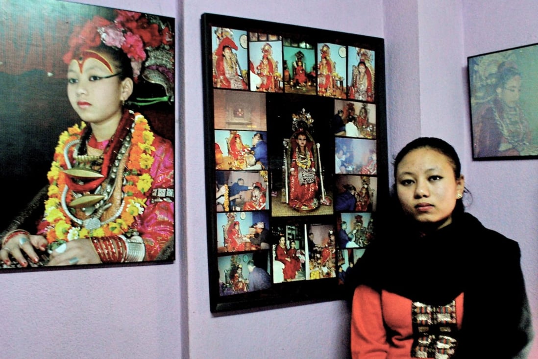 Chanira Bajracharya at home with pictures of her time as a living goddess. She returned to normal life at the age of 15. Photos: Bibek Bhandari
