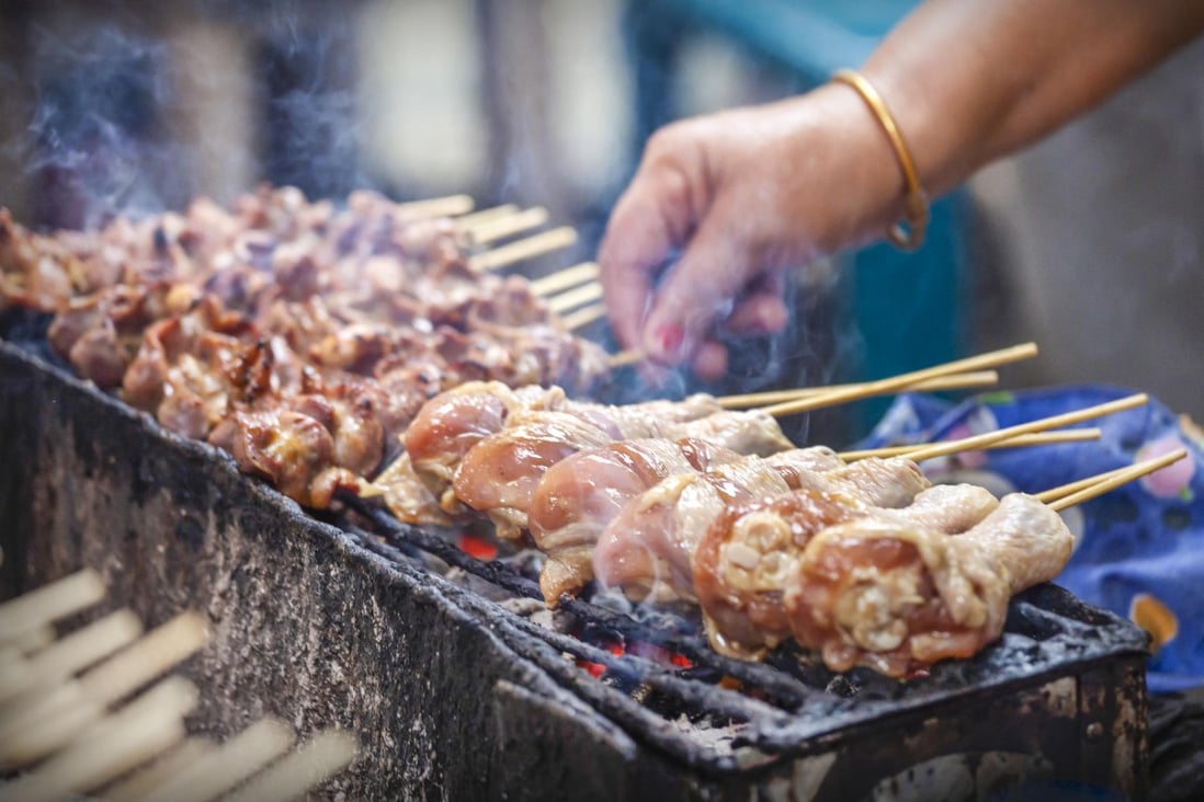 A charcoal grill in use on a street-food stall in Bangkok. Photo: Trizeps Photography