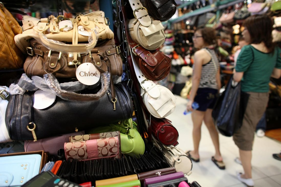 Fake luxury brands grace the shelves of a Beijing market. Photo: Bloomberg