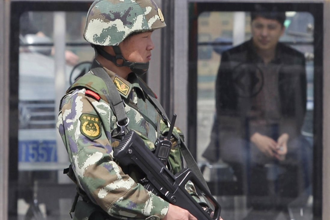 Armed police stand guard in Urumqi's Grand Bazaar following Wednesday's suicide attack. Ethnic unrest has hit business. Photo: Simon Song