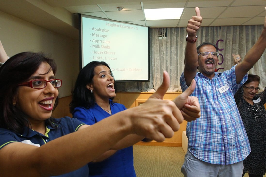 Inspire2Aspire's Veena Dansinghani (centre) and Mahesh Pamnani (right) in a Laughter yoga session.