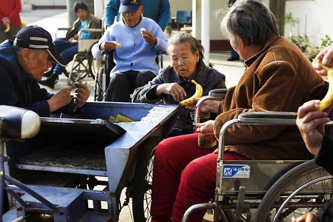 Residents enjoy the sunshine outside flats for the elderly in Beijing. More than 20 per cent of the capital's population are over 60. Photo: Ricky Wong